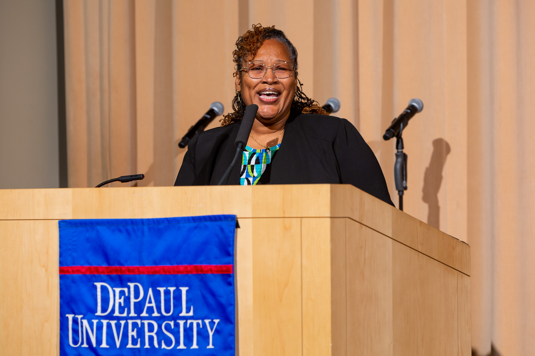 Sandra Bowen, senior grant and contracts specialists, leads the crowd in singing, “Lift Ev’ry Voice and Sing," by James Weldon Johnson. (DePaul University/Randall Spriggs)